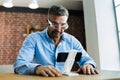 Mature Man Using Magnifying Glasses For Reading Small Text Royalty Free Stock Photo