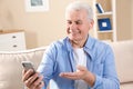 Mature man using video chat on mobile phone Royalty Free Stock Photo