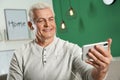 Mature man using video chat on mobile phone Royalty Free Stock Photo