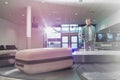 Mature man waiting for his suit case on baggage claiming area in airport