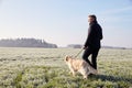 Mature Man Walking Dog In Frosty Landscape Royalty Free Stock Photo