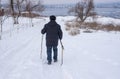 Man walking on a snowy road down to frozen Dnipro river in Ukraine Royalty Free Stock Photo