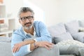 Mature man wearing eyeglasses sitting at home Royalty Free Stock Photo