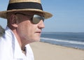 Mature man wearing a hat and sunglasses in summer. Royalty Free Stock Photo