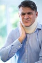 Mature Man Wearing Neck Brace Winces With Pain Royalty Free Stock Photo