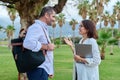 Mature man and woman business colleagues talking outdoors Royalty Free Stock Photo