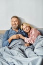 A mature man and woman cuddling