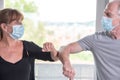 Man and woman having elbow greeting during covid outbreak