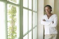 Mature man by wooden window. Royalty Free Stock Photo