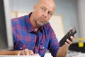 Mature man working with calculator