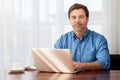 Mature man working at home in the kitchen Royalty Free Stock Photo