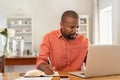 Mature man working on laptop at home Royalty Free Stock Photo
