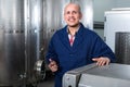 Mature man working in wine fermentation section Royalty Free Stock Photo