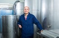 Mature man working in wine fermentation section Royalty Free Stock Photo