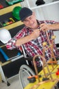 Mature manual worker in wheelchair