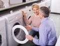 Mature married couple in shop of household appliances