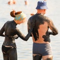 Mature married couple to be treated with mud on the mud lake at the resort