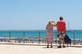 Mature married couple on the waterfront in the Sitges, Barcelona, Catalunya, Spain. Copy space for text.