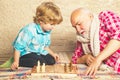Mature man with little boy playing chess. Checkmate. Cute little boy playing chess. Childhood. Grandfather and grandson