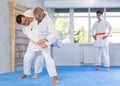 Mature men working on martial arts techniques and maneuvers in training fight Royalty Free Stock Photo