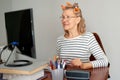 Mature middle aged in glasses using laptop typing email working at home office, lady searching information on internet Royalty Free Stock Photo