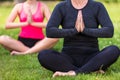 Mature Middle Aged and Young Woman Practicing Yoga Outside