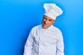 Mature middle east man wearing professional cook uniform and hat winking looking at the camera with sexy expression, cheerful and Royalty Free Stock Photo