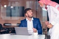 Mature Middle Eastern businessman wearing ghoutra in meeting