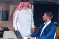 Mature Middle Eastern businessman wearing ghoutra in meeting