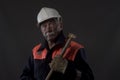 Mature miner covered in coal dust holding a pick axe Royalty Free Stock Photo