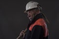 Mature miner covered in coal dust holding a pick axe Royalty Free Stock Photo