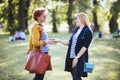 Mature mother and adult daughter enjoying in the park Royalty Free Stock Photo