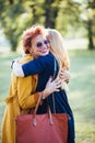 Mature mother and adult daughter hugging in the park Royalty Free Stock Photo