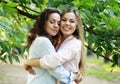 mature mother and adult daughter hugging in the park on a summer day Royalty Free Stock Photo
