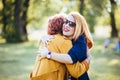 Mature mother and adult daughter hugging in the park Royalty Free Stock Photo