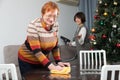 Mature mother and daughter are preparing room for the New Year