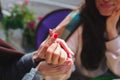 Mature mother and her young daughter sit together in cafe or restaurant. Cut view of girl holding engagement ring with Royalty Free Stock Photo