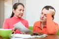 Mature mother scolds daughter for bills or credits