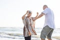 Mature mother and son dancing on the beach Royalty Free Stock Photo