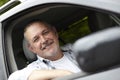 Mature Motorist Looking Out Of Car Window