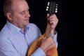 Mature musician playing with mandolin Royalty Free Stock Photo