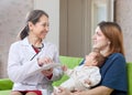 Mature pediatrician of prescribes to newborn baby the medicatio Royalty Free Stock Photo