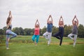 Mature people doing yoga exercise outdoor. Royalty Free Stock Photo