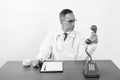 Mature Persian man doctor behind desk in black and white Royalty Free Stock Photo