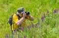 Mature photographer taking a photo of wild nature Royalty Free Stock Photo