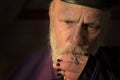Mature priest, praying with rosary beads Royalty Free Stock Photo
