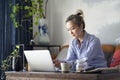 Mature asian woman working from home using laptop and cellphone Royalty Free Stock Photo