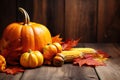 Mature pumpkins, corn and autumn yellow leaves on a wooden background Royalty Free Stock Photo