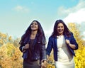 Mature real mother with daughter outside autumn fall in park