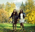 Mature real mother with daughter outside autumn fall in park